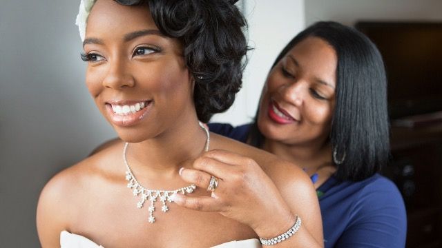 Bride wants Mom to walk her down the aisle; family pressures Mom to back out. AITA?