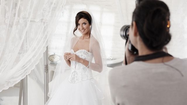 Bride surprises old acquaintance into being her wedding photographer for free.