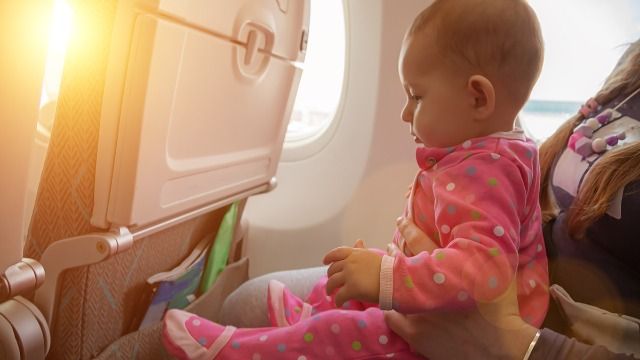 Man can't stop his child from kicking plane seat; asks if he handled it wrong.