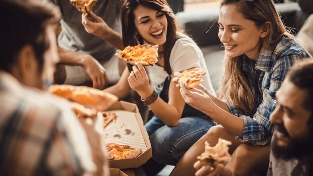 Woman buys pizza to share with roomies, takes biggest slices, roommate gets mad. AITA?